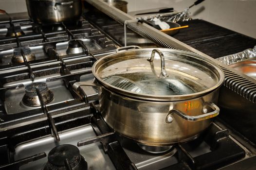 real dirty restaurant kitchen, pot on stove