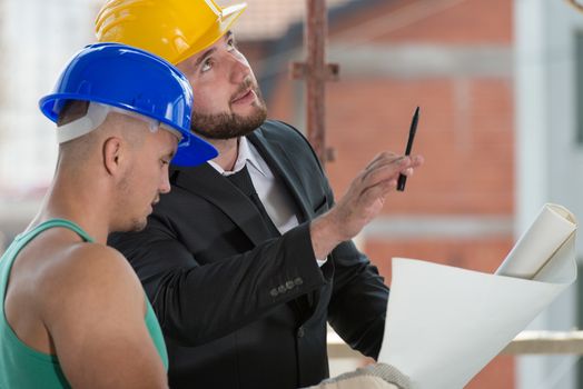 Group Of Male Architect And Construction Worker On Construction Site