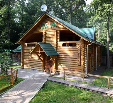 A general view of the log building modern baths in summer