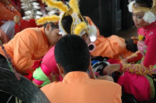 Bandung, Indonesia - March 9, 2008: Dancer member and musical crew gather together and make preparation before get performing on stage at Tegalega Park Bandung, West Java-Indonesia.