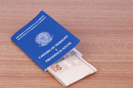 Brazilian work document and social security document (carteira de trabalho) and brazilian currency (Real)
