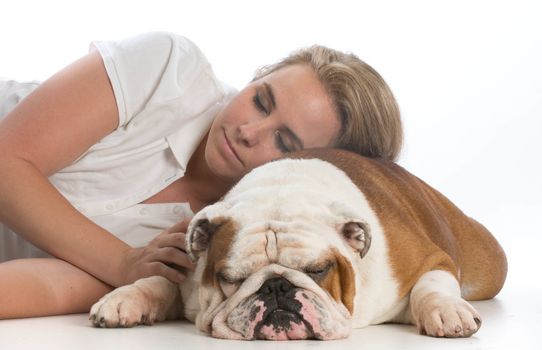 woman resting her head on her english bulldog on white background