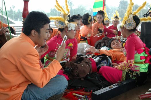 Bandung, Indonesia - March 9, 2008: Dancer member and musical crew gather together and make preparation before get performing on stage at Tegalega Park Bandung, West Java-Indonesia.