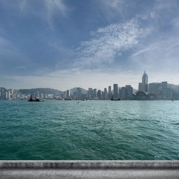 Hong Kong city scenery with Victoria Harbor and skyscrapers.