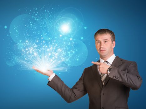 Business man hold magic light in hand. Success concept