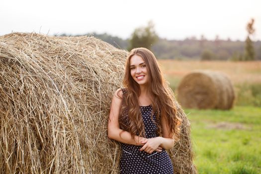 Rural, evening. Beautiful girl in cute dress