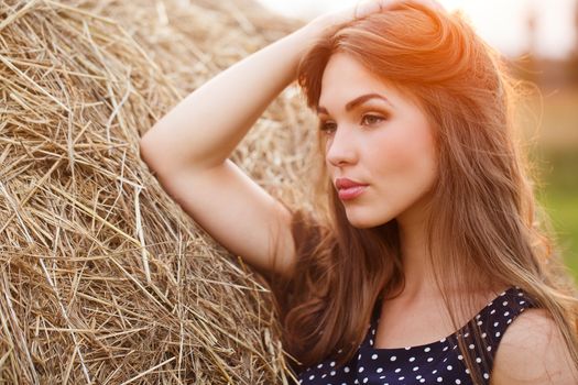 Rural, evening. Beautiful girl in cute dress