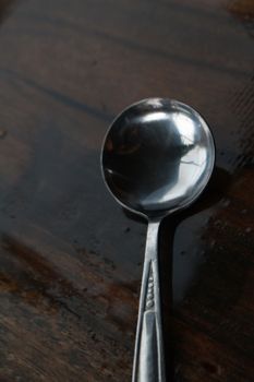 The ball spoon is on the wet table after raining.