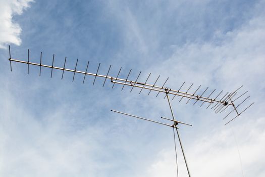 the beautiful television antenna on the top roof under the blue sky with white cloud