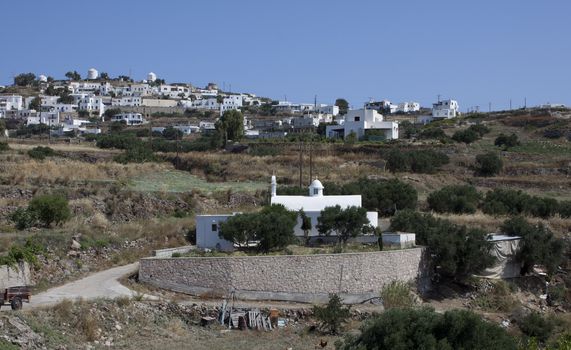 Small Orthodox Church in front to typical Cycladic town