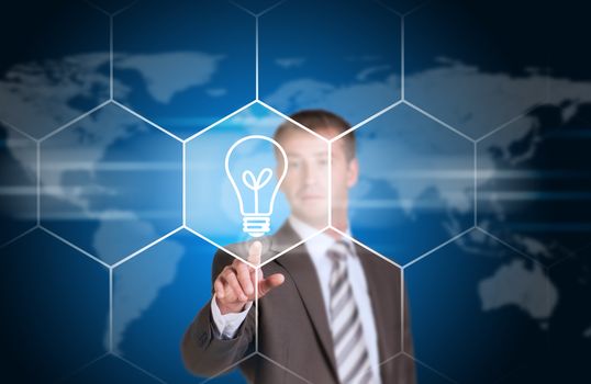 Business man pointing her finger at light bulb icon. Technology concept. World map as backdrop