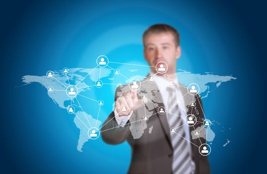 Business man pointing her finger at network icons. Technology concept. World map as backdrop