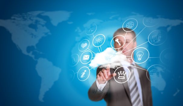 Business man hold pointing her finger at cloud with computer icons. Technology concept. World map as backdrop