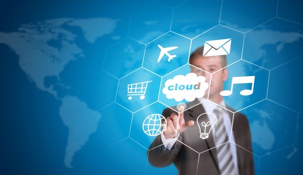 Business man pointing her finger at cloud with icons. Technology concept. World map as backdrop