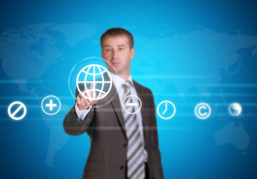 Businessman in suit pointing her finger at cloud icons. World map as backdrop