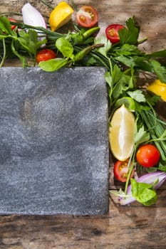 Presentation of a flat stone with vegetables