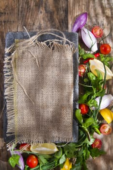 Presentation of a flat stone with vegetables