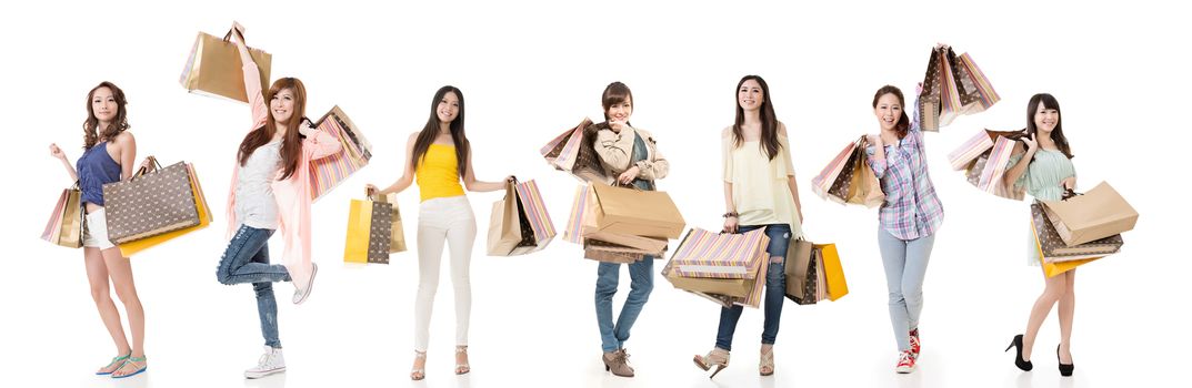 Attractive Asian women shopping and holding bags, full length portrait isolated on white background.