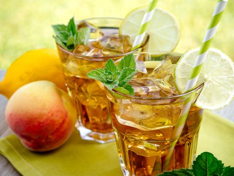 Refreshing peach, lime and mint ice tea served outdoors