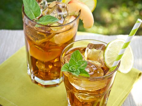 Refreshing peach, lime and mint ice tea served outdoors