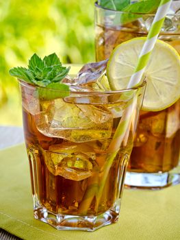 Refreshing peach, lime and mint ice tea served outdoors