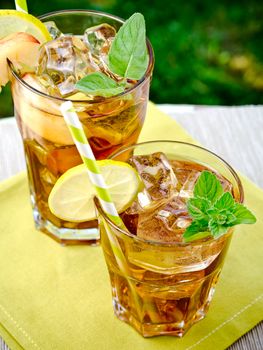 Refreshing peach, lime and mint ice tea served outdoors