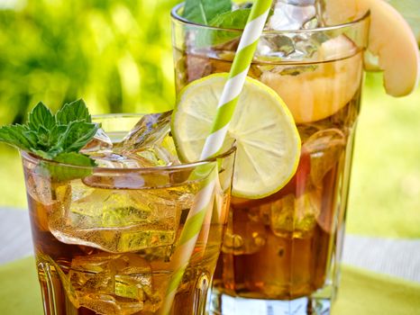 Refreshing peach, lime and mint ice tea served outdoors