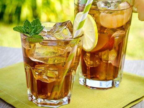 Refreshing peach, lime and mint ice tea served outdoors