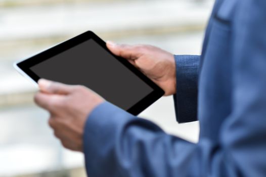 Cropped image of male hand holding digital tablet