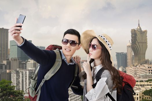Asian couple travel and selfie in Macau, Asia.
