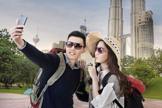 Asian couple travel and selfie in Kuala Lumpur, Malaysia.