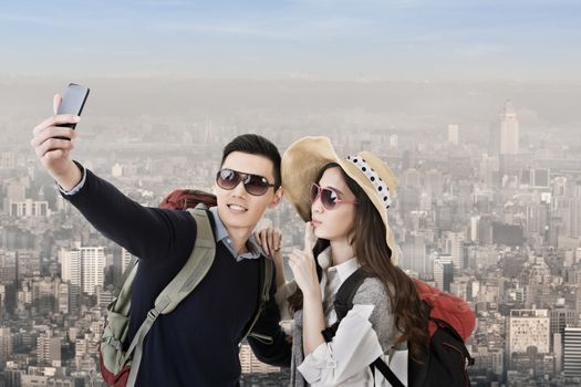 Asian couple travel and selfie in the city.