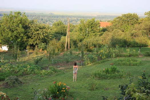 Young woman walking in the garden