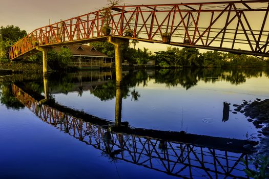 Bridge and reflection view during sunrise in a rural area