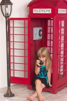 child girl calling in red in a phone