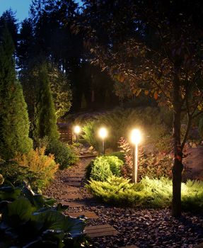 Illuminated home garden path patio lights in evening dusk