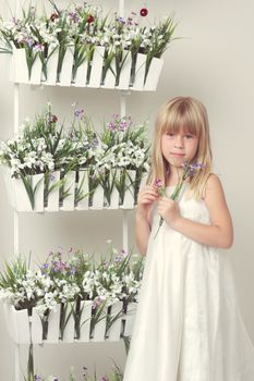 beautiful girl with summer flowers in the garden center