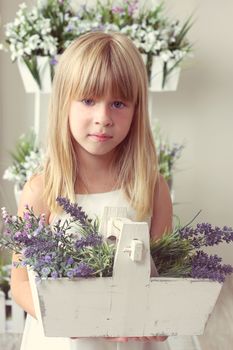 beautiful girl with summer flowers in the garden center