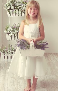 beautiful girl with summer flowers in the garden center
