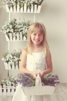beautiful girl with summer flowers in the garden center