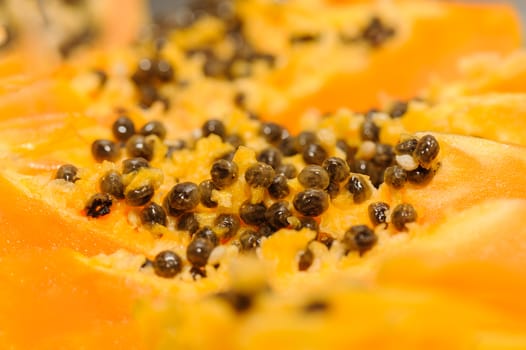fersh juicy yellow papaya extreme closeup, selective focus