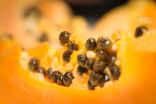 fersh juicy yellow papaya extreme closeup, selective focus