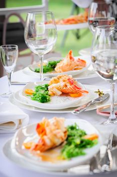 Prepared lobster and sea weed served on plates