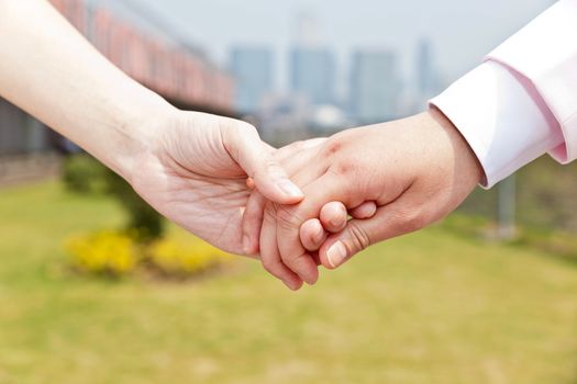 Close up of couple holding hands