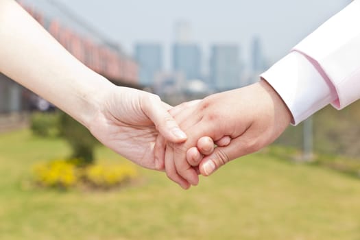 Close-up of couple holding hands