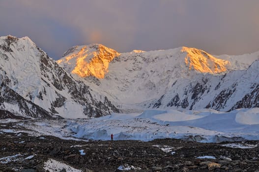 Inylcheck glacier in Kyrgyzstan with Pik Pobeda peak lit by early morning sun