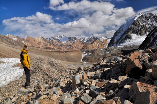 Young adventurer hiking in Pamir mountains in Tajikistan