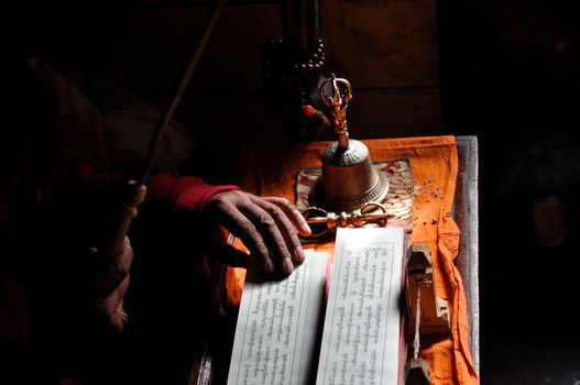 A monk in Lamayuru monastery sitting behind a desk 