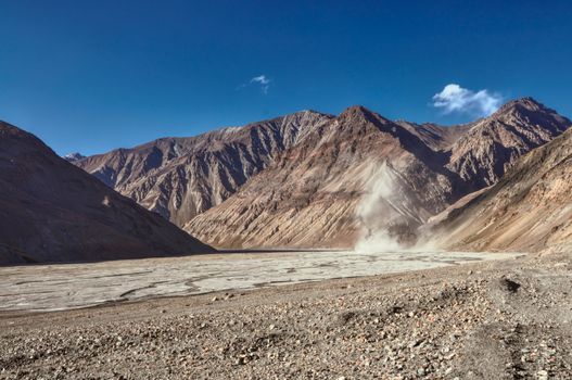 Panoramic view of the sunlit slopes in Pamir Mountains 