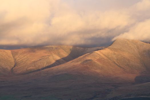 A left to right ridge leads to the clouded peak of Yr Elen, Carneddau range, Gwynedd, Wales, UK.